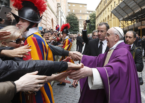Pope Francis greets people after celebrating mass at St. Anne's Parish within the Vatican March 17. The new pope greeted every person leaving the small church and then walked over to meet people waiting around St. Anne's Gate. (CNS photo/Paul Haring)